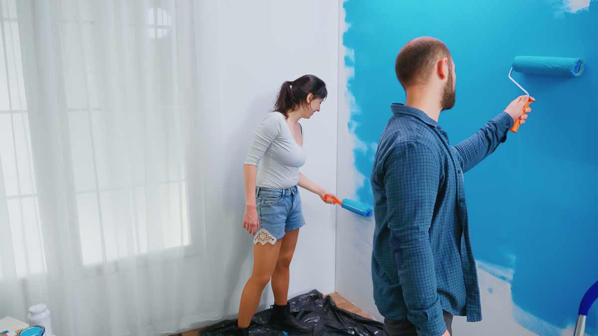 Couple painting wall