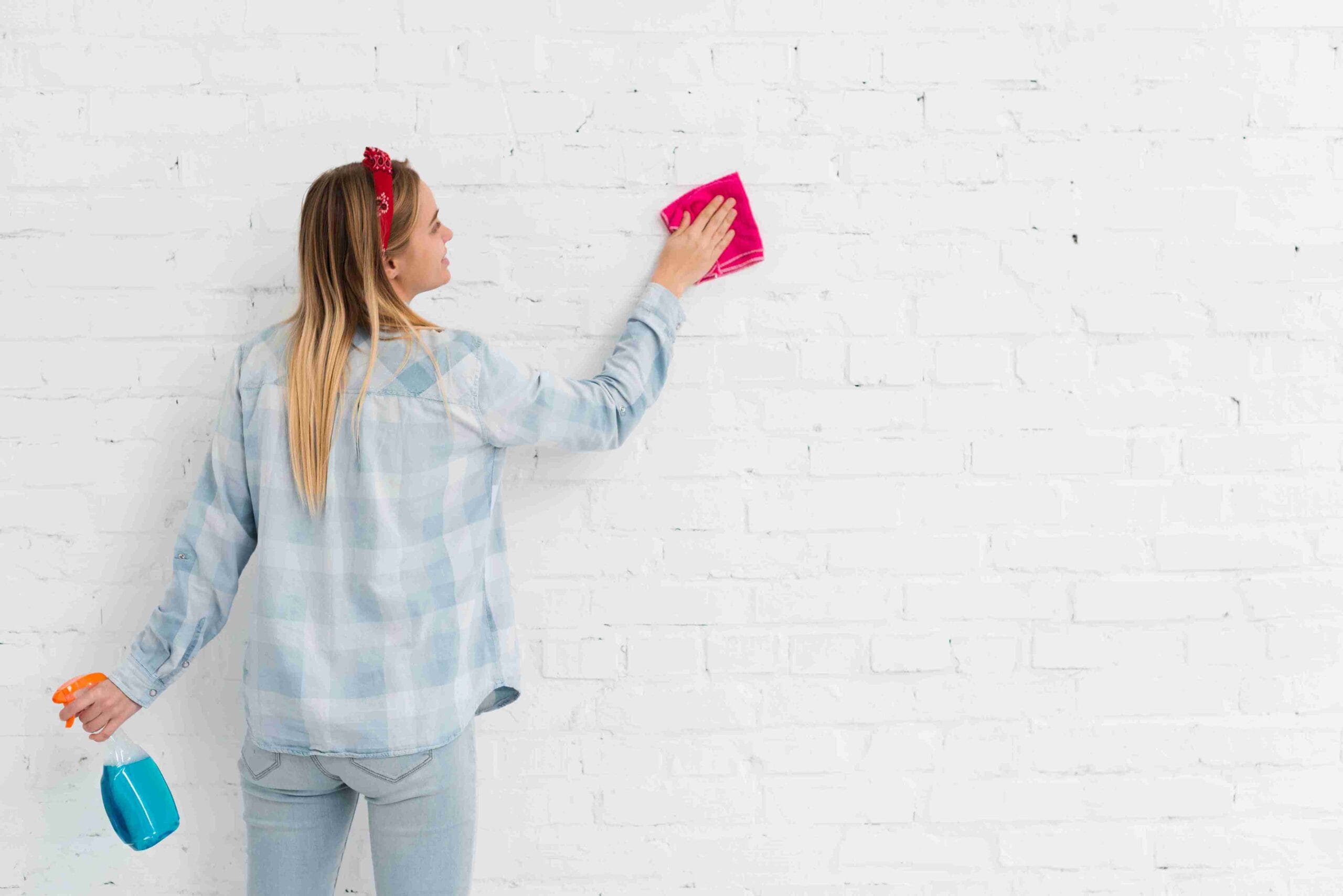 woman cleaning wall