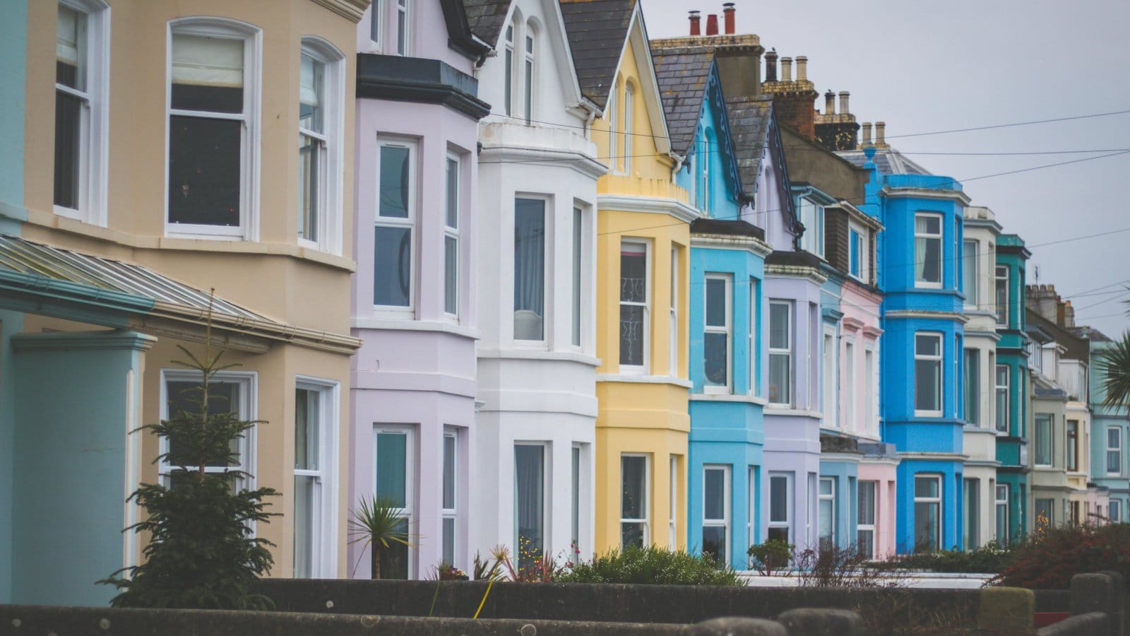 Vibrant row of Victorian-style houses with colorful facades in a residential neighborhood