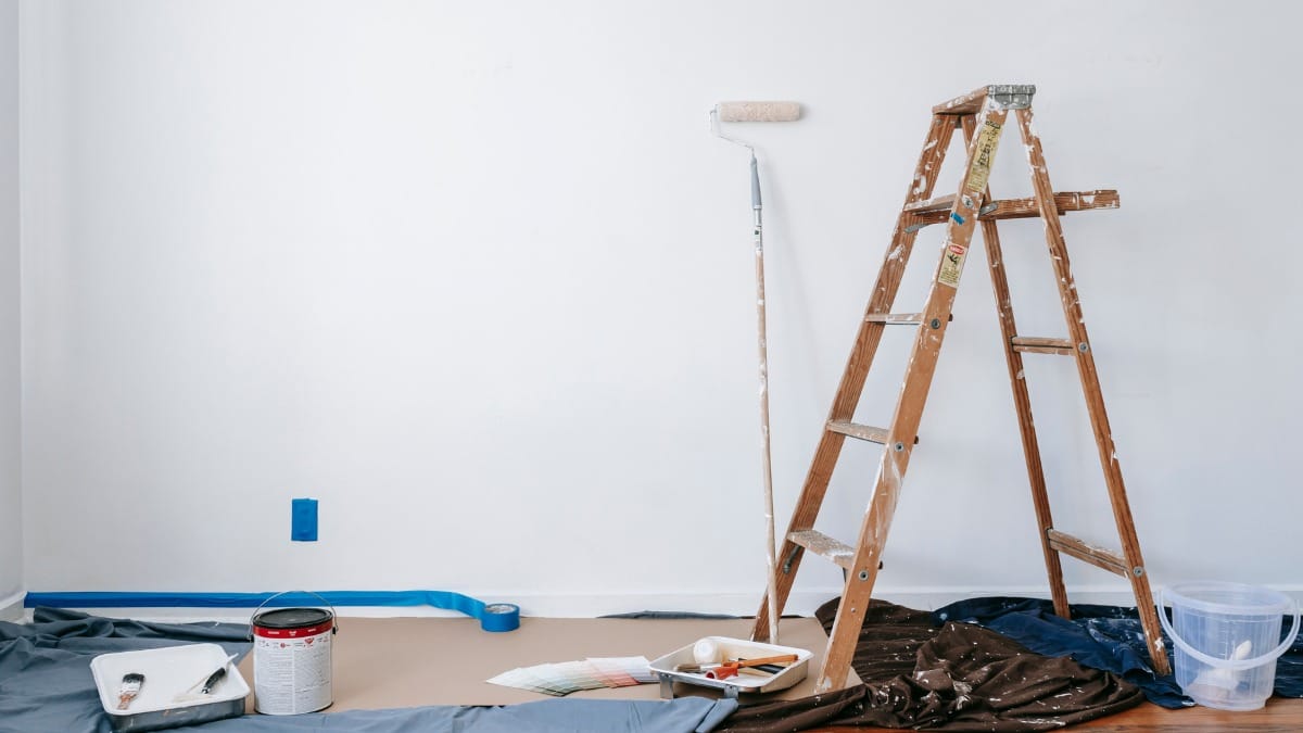 Wooden stepladder and paint supplies